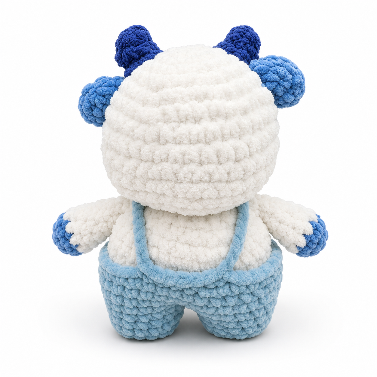 Back view of handmade crochet Blueberry Cow plush with blue overalls.