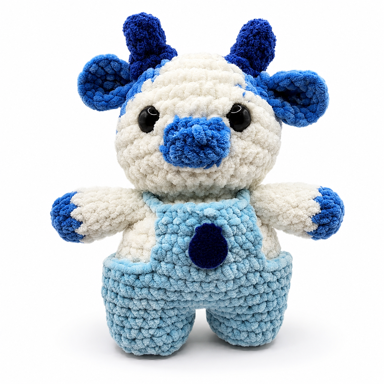 Handmade crochet Blueberry Cow plush with blue horns, ears, nose, and overalls.