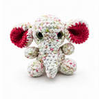 Handmade crochet elephant plush with speckled white yarn, pink inner ears, glossy eyes, and soft trunk.