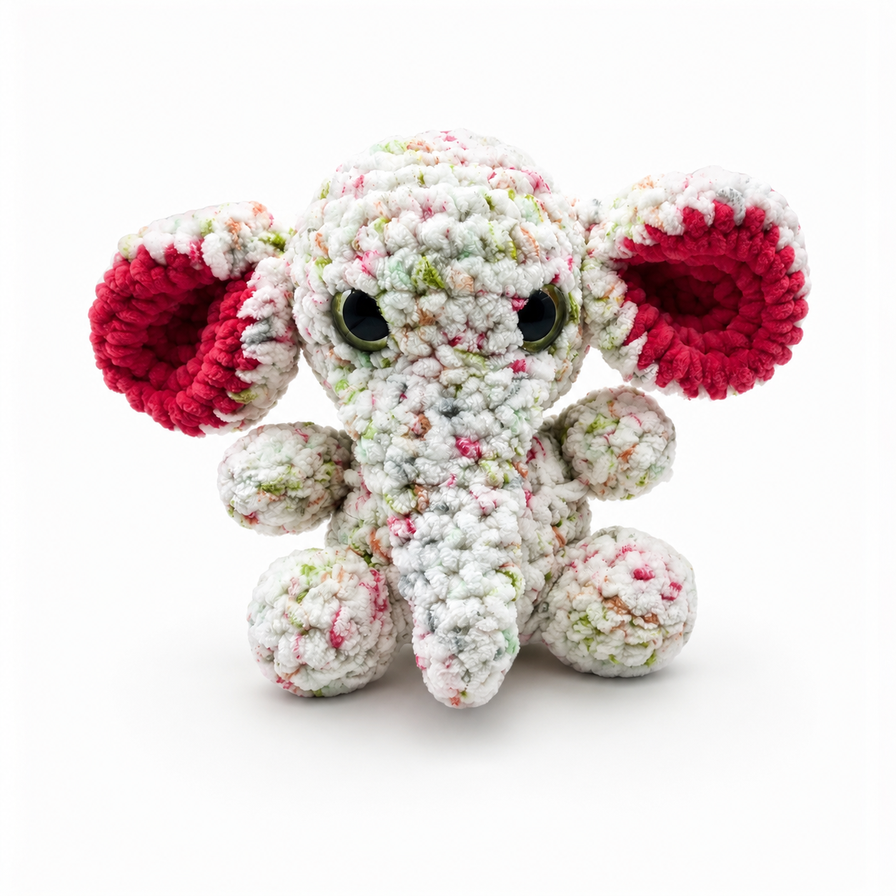 Handmade crochet elephant plush with speckled white yarn, pink inner ears, glossy eyes, and soft trunk.